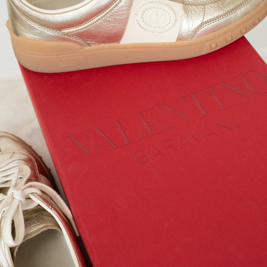Gold and cream sneakers on red Valentino box