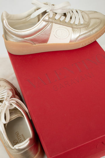 Gold and cream sneakers on red Valentino box