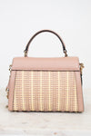 Pink handbag with wicker design on a white background
