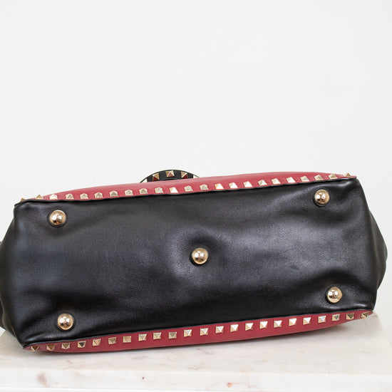 Black handbag with gold studs on a white background