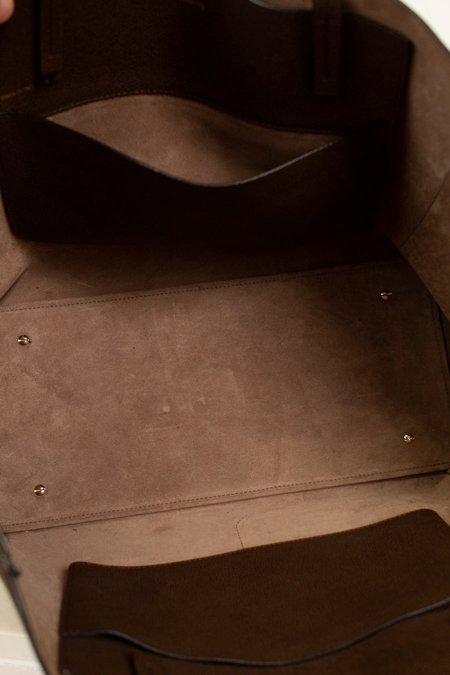 Close-up of a brown leather bag with stitching details