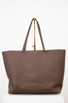 Brown tote bag with a gold clasp on a white background
