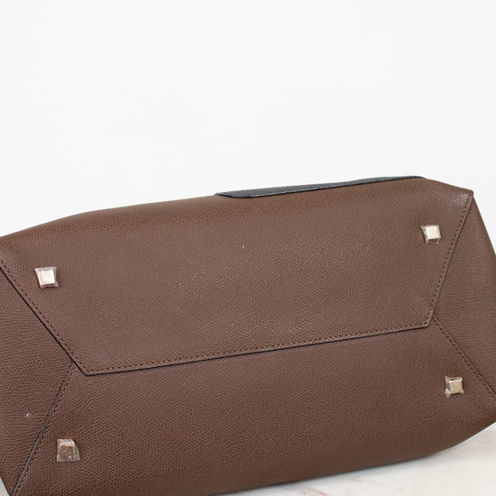 Brown base of bag with silver studs on a white background