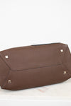 Brown base of bag with silver studs on a white background