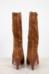 Pair of brown knee-high boots on a white background