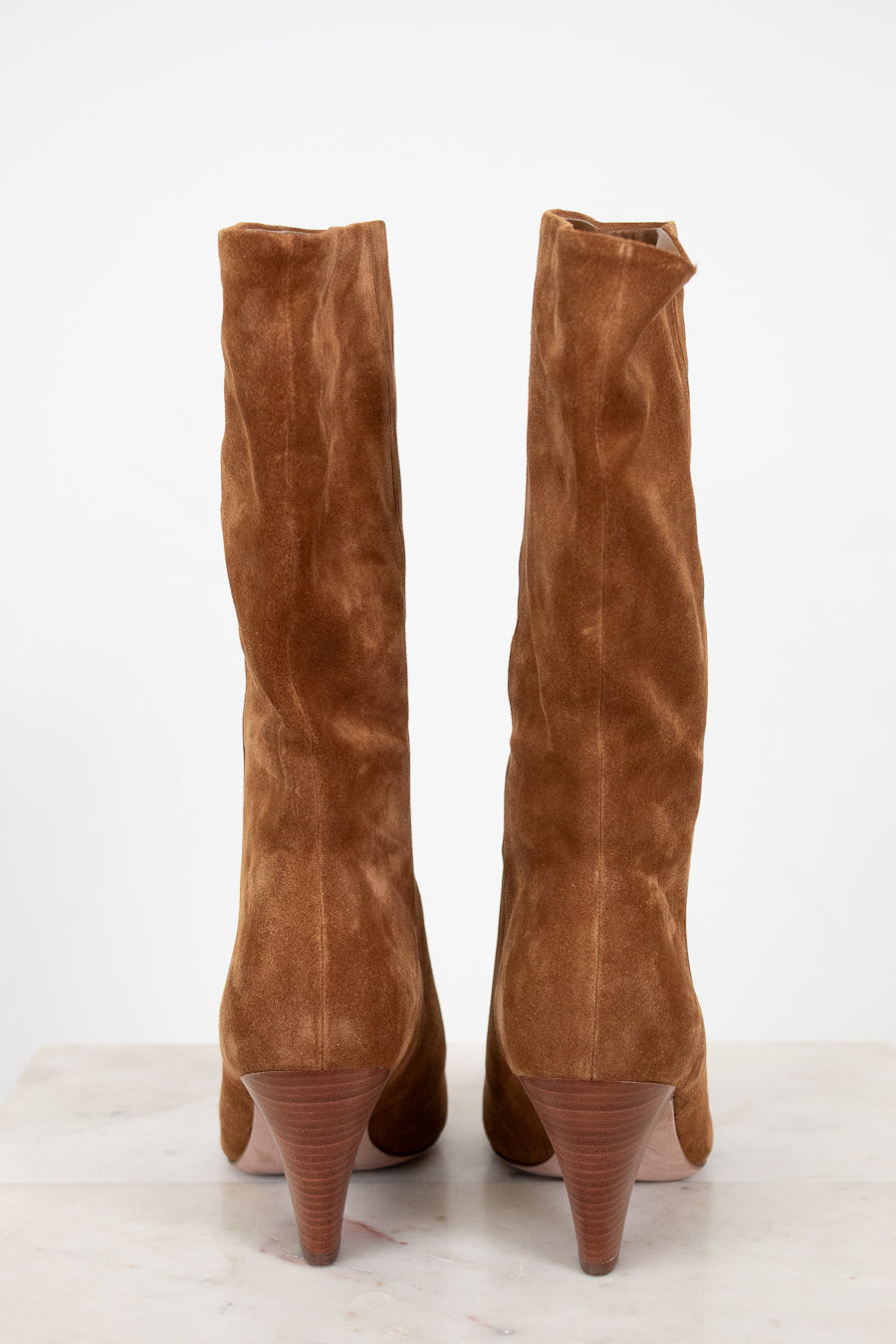Pair of brown knee-high boots on a white background