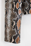 Close-up of snake skin patterned fabric on a white background