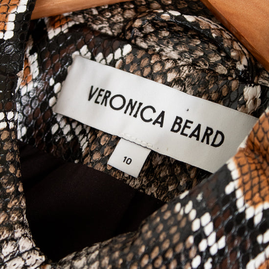 Close-up of a patterned garment with a Veronica Beard label inside a wooden box.