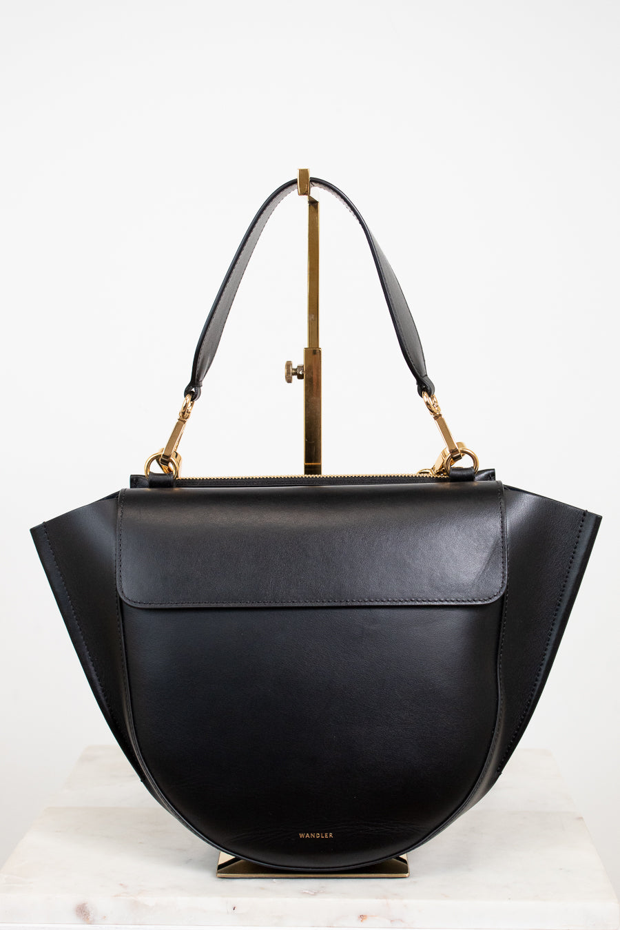 Black handbag with gold accents on a white background