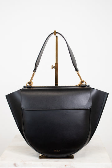 Black handbag with gold accents on a white background