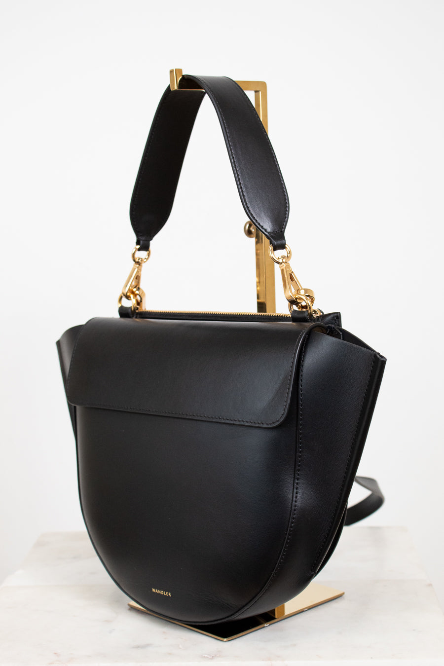 Black handbag with gold accents on a white background
