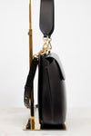 Black handbag with gold accents on a white background