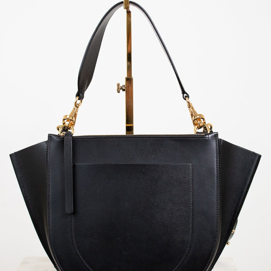 Black handbag with gold accents on a white background