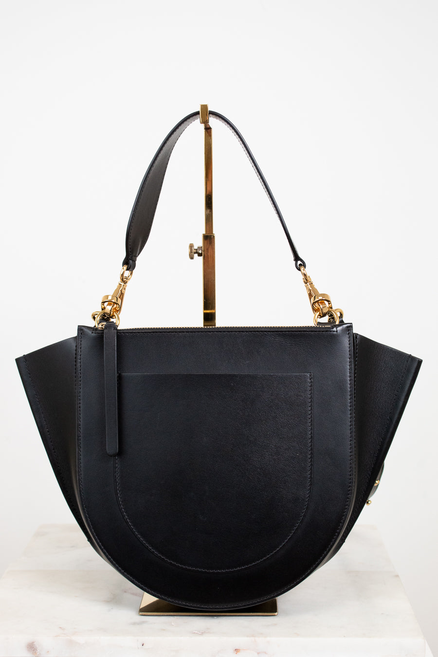 Black handbag with gold accents on a white background
