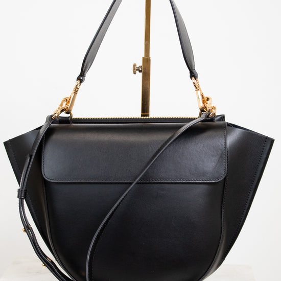 Black handbag with gold accents on a white background