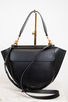 Black handbag with gold accents on a white background