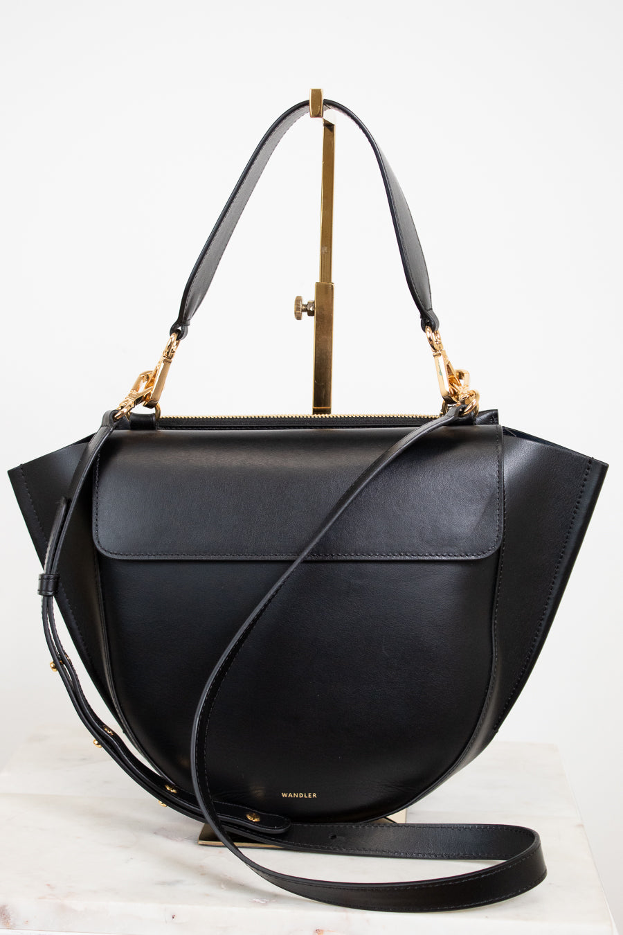 Black handbag with gold accents on a white background