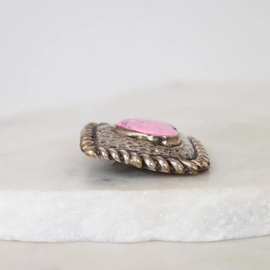 Decorative object with pink center and textured surface on a white background