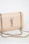 Beige handbag with chain strap on a light background