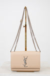 Beige handbag with chain strap on a white background