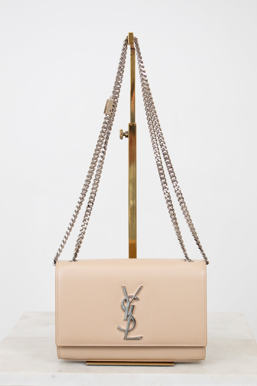 Beige handbag with chain strap on a white background