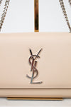 Beige handbag with a prominent logo on a white background