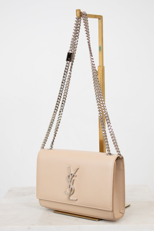 Beige handbag with chain strap on a white background