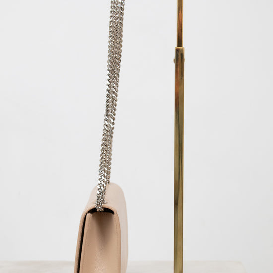 Beige handbag with a chain strap on a white background