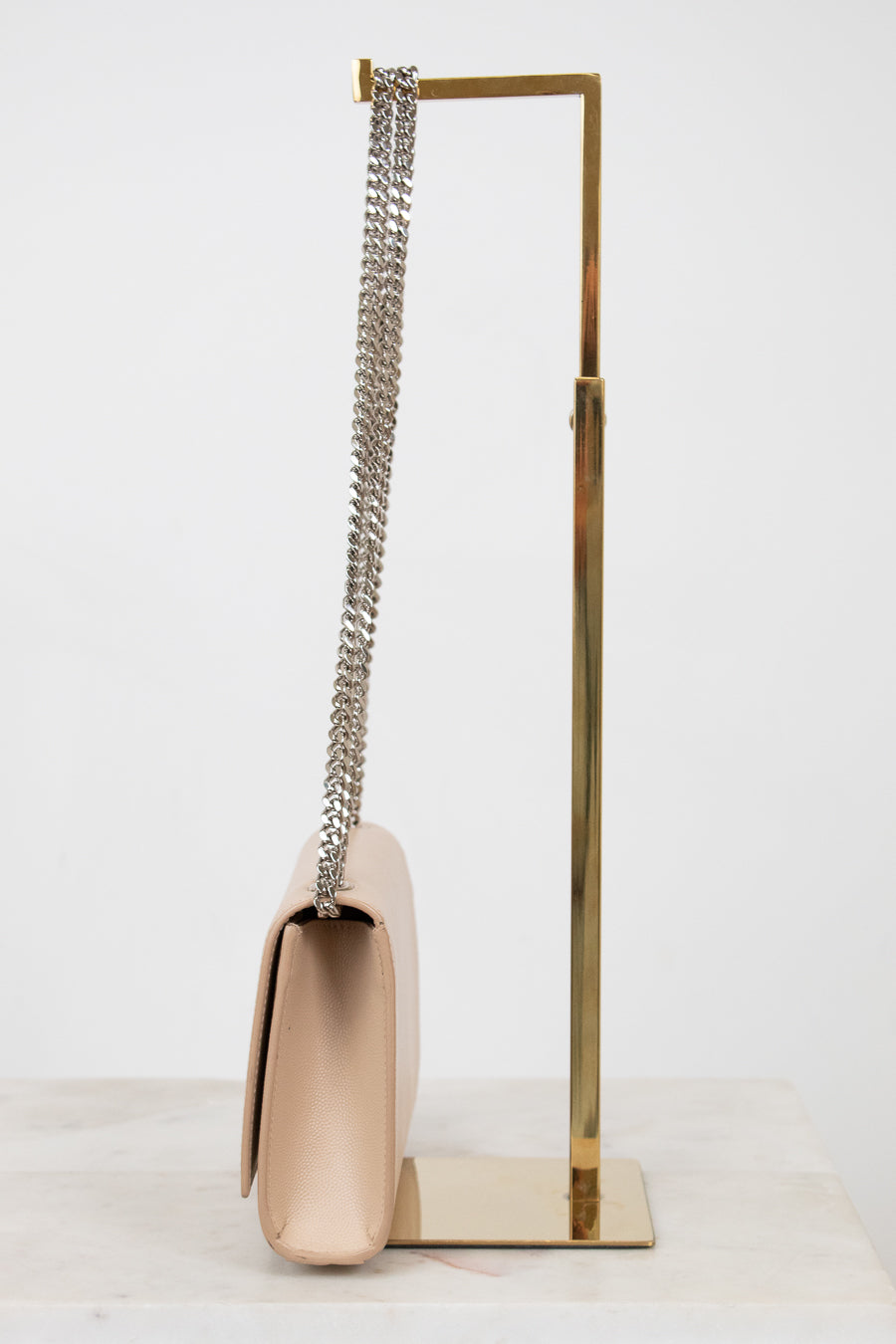 Beige handbag with a chain strap on a white background