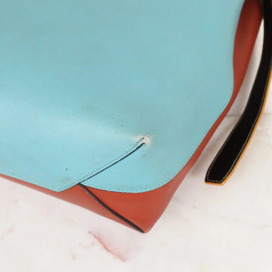 Close-up of a shoe sole with a small white object on a blue and white background