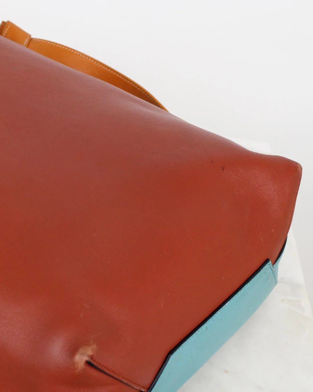 Close-up of a multicolored leather bag with a white background