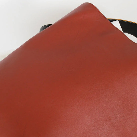 Close-up of a brown leather surface with a white background
