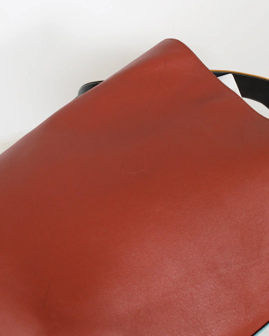 Close-up of a brown leather surface with a white background