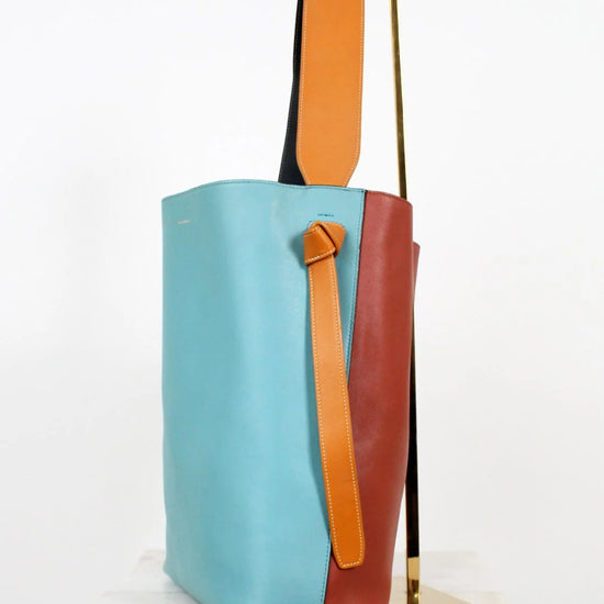 Colorful tote bag with a mix of blue, orange, and brown on a white background