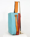 Colorful tote bag with a mix of blue, orange, and brown on a white background