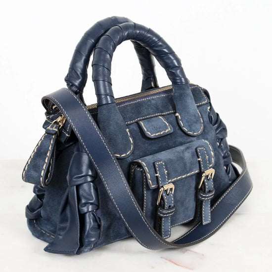 Blue handbag with a strap on a white background