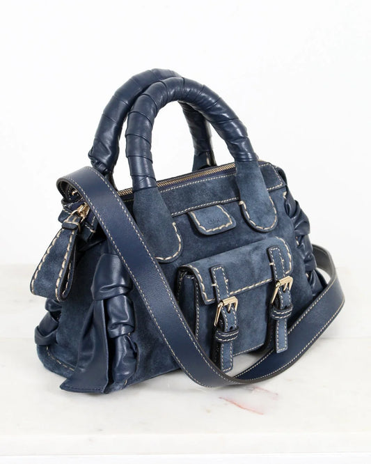 Blue handbag with a strap on a white background