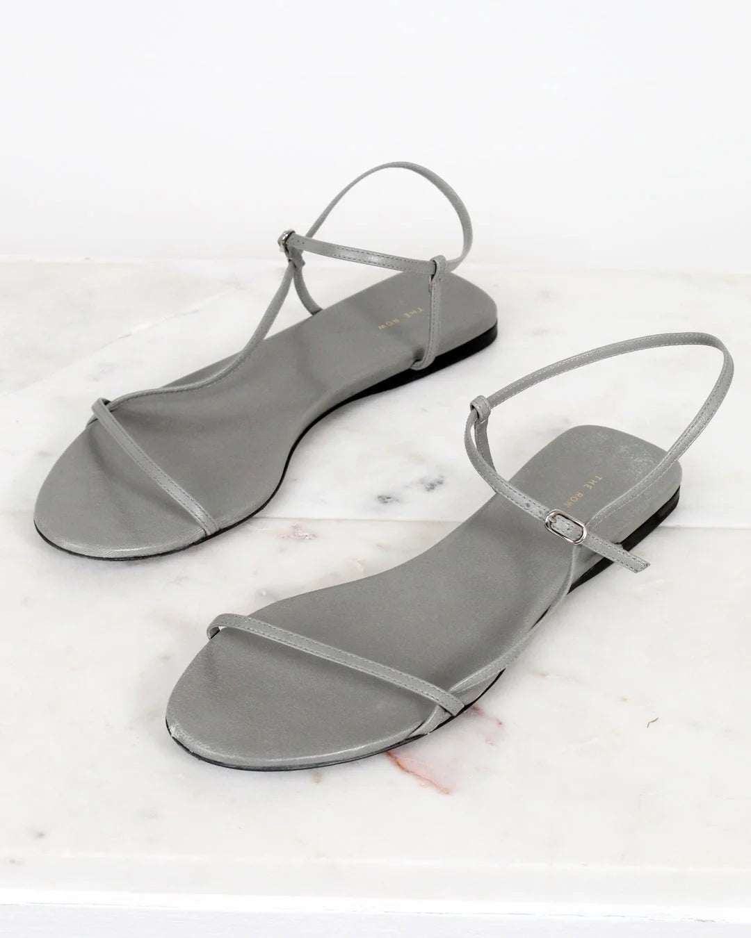 Pair of gray sandals on a white background