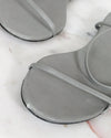 Gray sandal on a white surface