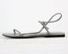 Gray sandal with a thin strap on a white background