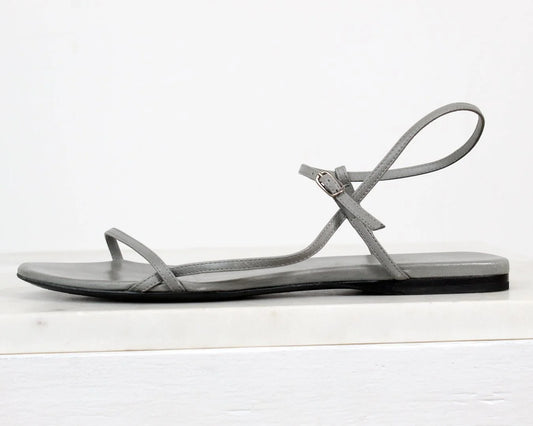 Gray sandal with a thin strap on a white background