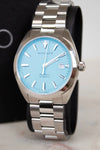 Silver watch with a blue face on a marble surface