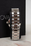 Close-up of a silver watch band on a black background with 'Oval' branding.