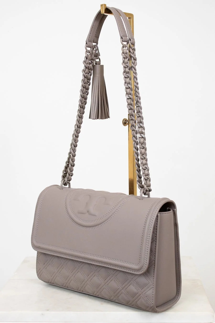 Gray handbag with chain strap on a white background