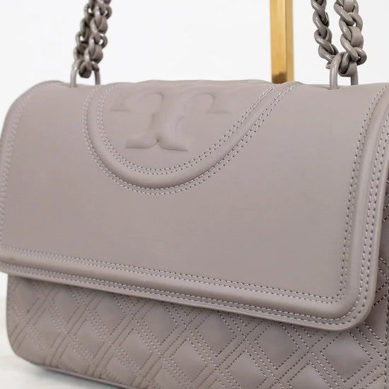 Gray handbag with a chain strap on a white background