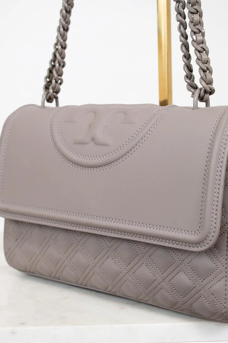Gray handbag with a chain strap on a white background