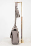 Gray handbag with braided chain strap on a white background