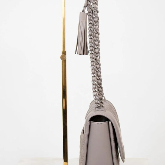 Gray handbag with a chain strap on a white background