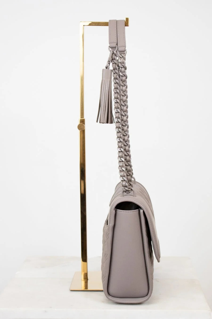Gray handbag with a chain strap on a white background
