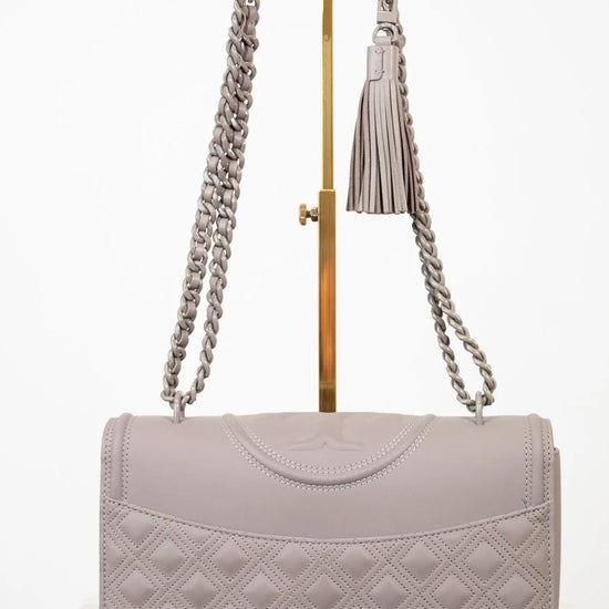 Quilted gray handbag with a chain strap on a white background